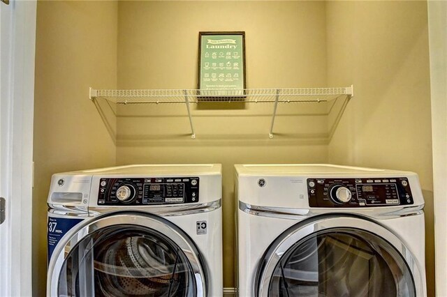 clothes washing area featuring laundry area and separate washer and dryer