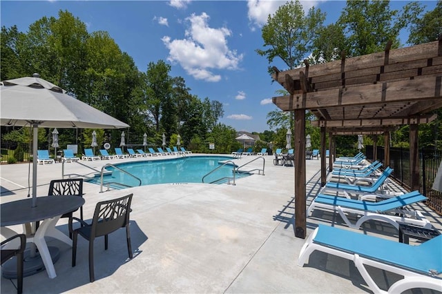 pool featuring a pergola, a patio, and fence