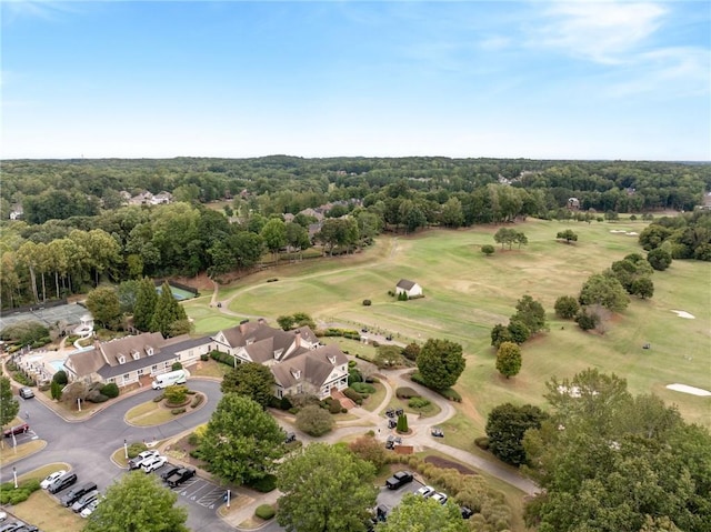 view of property location with a pool and a golf club