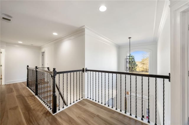 bedroom with a raised ceiling, light wood finished floors, baseboards, a ceiling fan, and crown molding