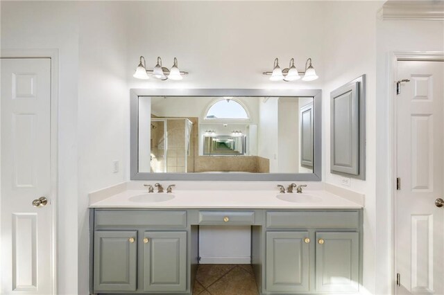 full bath with double vanity, a shower with door, and tile patterned floors
