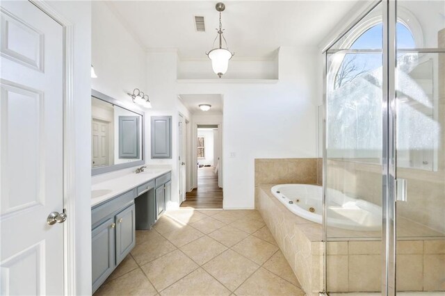 bathroom featuring double vanity, an enclosed shower, and tile patterned floors