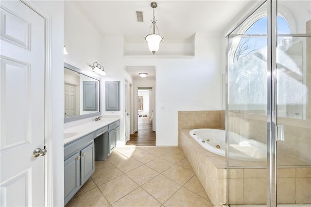 full bathroom with tile patterned flooring, double vanity, a whirlpool tub, ornamental molding, and a shower with shower door