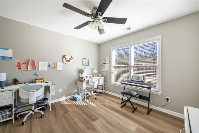 bedroom featuring wood finished floors, baseboards, and ceiling fan