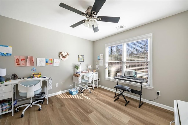 home office with wood finished floors, baseboards, and ceiling fan