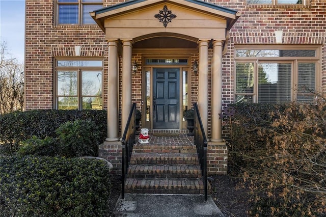 view of exterior entry with brick siding