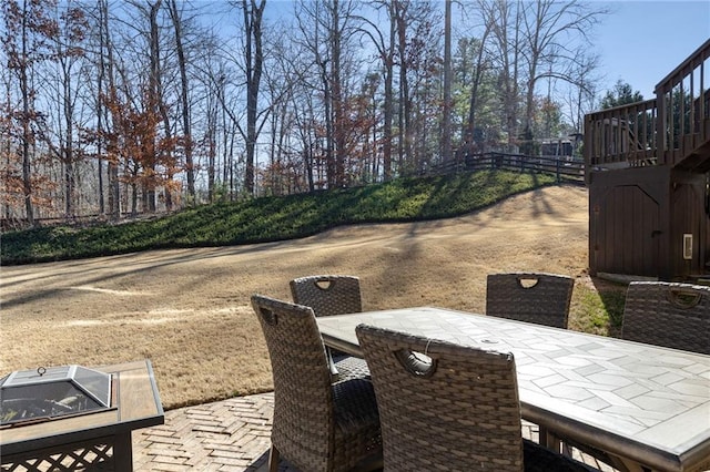 view of patio with outdoor dining area and stairway