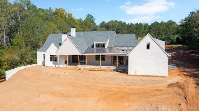615 Hickory Flt, Milton, GA 30004 - view of front of property featuring a chimney, a porch, and driveway