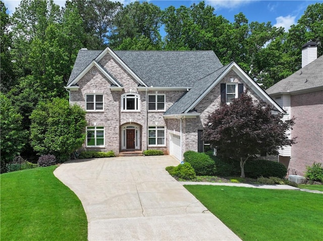 993 Southerby Ln, Alpharetta, GA 30004 - view of front of home with concrete driveway, a front yard, brick siding, roof with shingles, and an attached garage