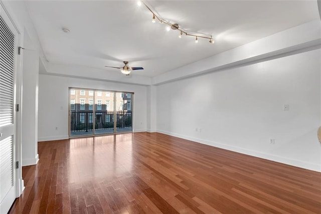 spare room with wood-type flooring and ceiling fan