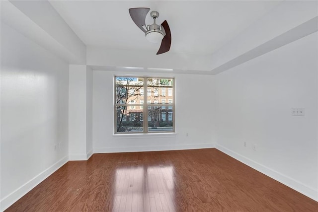 empty room featuring ceiling fan and dark hardwood / wood-style flooring