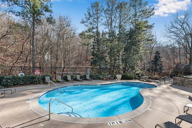 view of swimming pool featuring a patio area