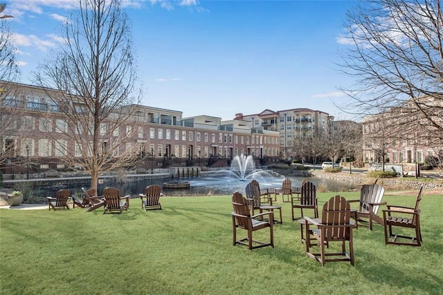 view of community with a lawn and a water view