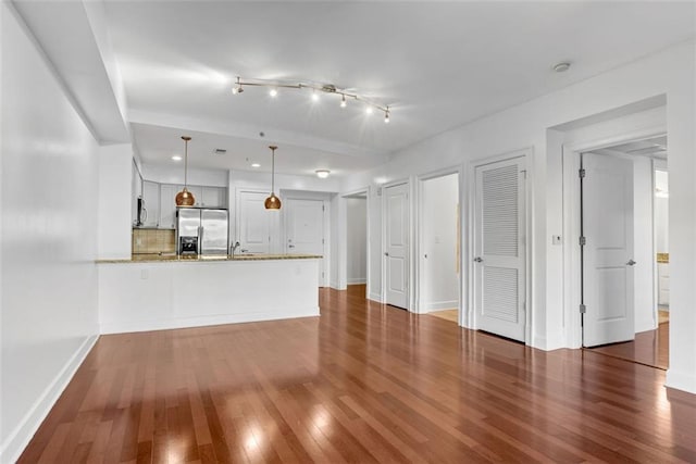 unfurnished living room with dark wood-type flooring