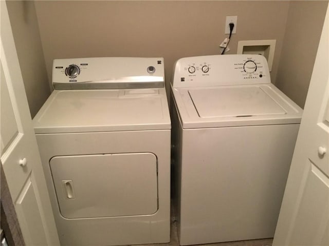 washroom featuring laundry area and separate washer and dryer