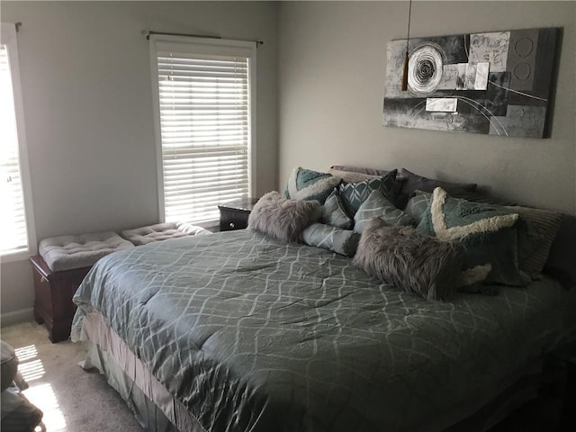 bedroom featuring baseboards and carpet floors