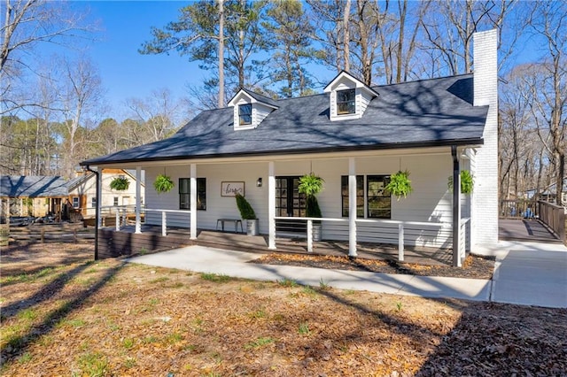 view of front of property featuring a porch and a chimney