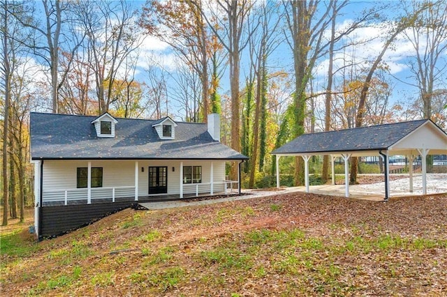 view of front of home with a porch and a chimney