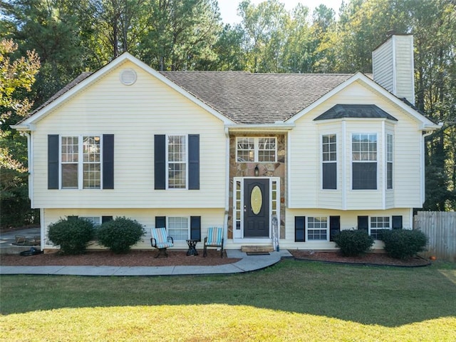 raised ranch with a front yard