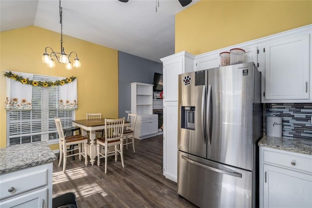 kitchen featuring white cabinets, tasteful backsplash, hanging light fixtures, dark hardwood / wood-style flooring, and stainless steel fridge with ice dispenser