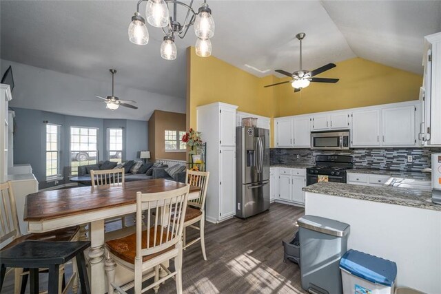 kitchen featuring white cabinets, pendant lighting, appliances with stainless steel finishes, light stone counters, and dark hardwood / wood-style flooring