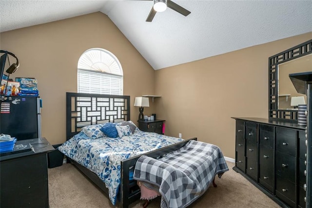 bedroom with lofted ceiling, black fridge, light colored carpet, and ceiling fan