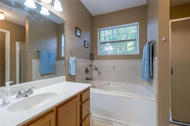 bathroom with vanity and independent shower and bath