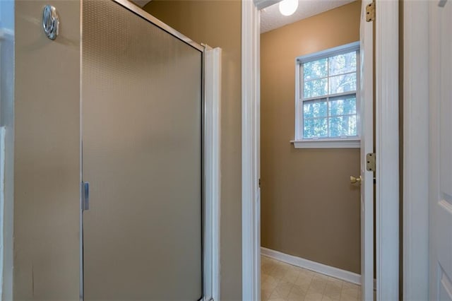 bathroom featuring a shower with door