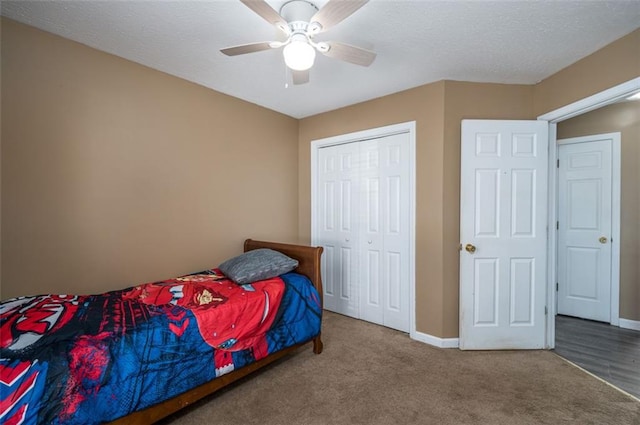 carpeted bedroom featuring a closet and ceiling fan