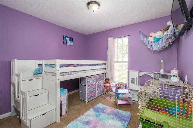 bedroom featuring carpet and a textured ceiling