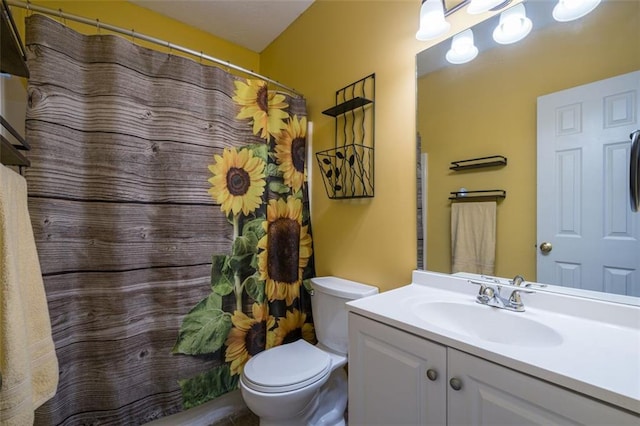 bathroom featuring vanity, toilet, and curtained shower