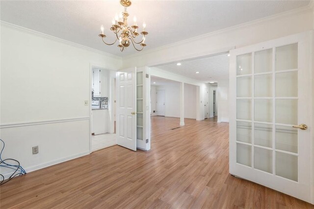 unfurnished dining area with hardwood / wood-style flooring, a notable chandelier, and crown molding