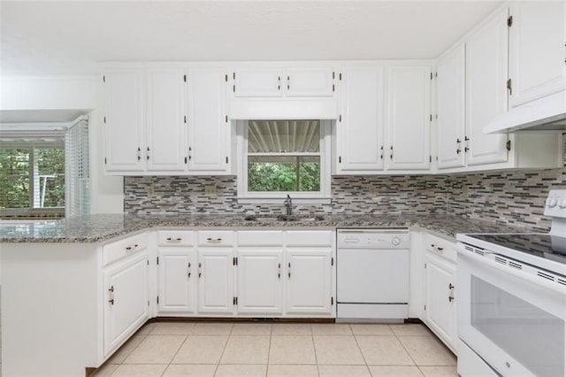 kitchen featuring light stone countertops, white appliances, sink, light tile patterned floors, and white cabinetry