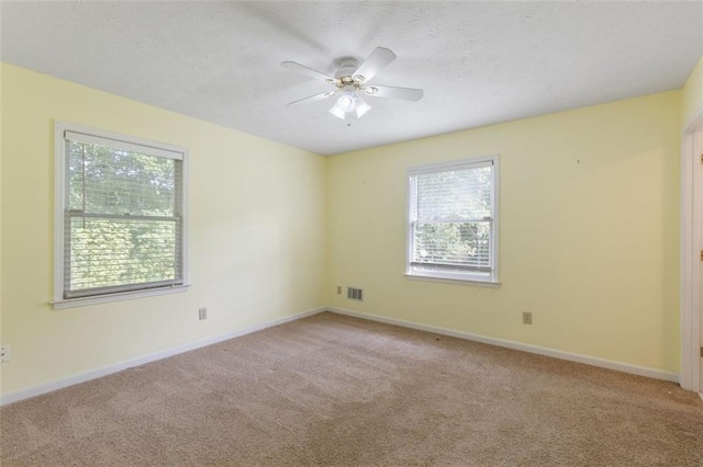 unfurnished room featuring light colored carpet and ceiling fan