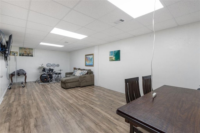 office area with a paneled ceiling and hardwood / wood-style floors