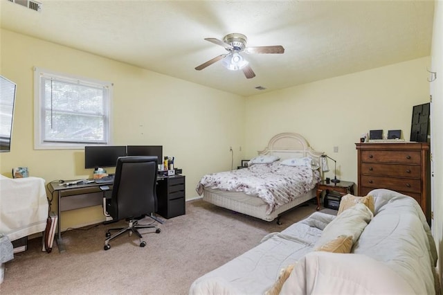 bedroom with ceiling fan and light colored carpet