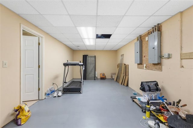 exercise area featuring electric panel and a drop ceiling