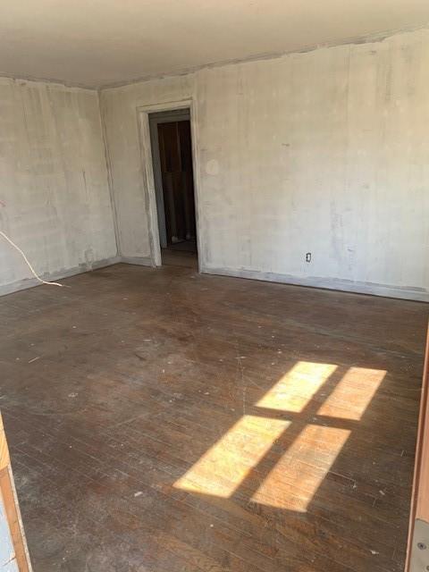 unfurnished room with wood finished floors