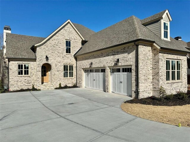 french country inspired facade with brick siding and roof with shingles