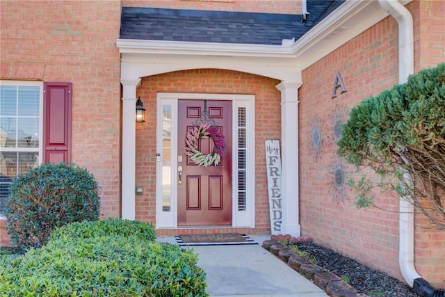 property entrance with brick siding and roof with shingles