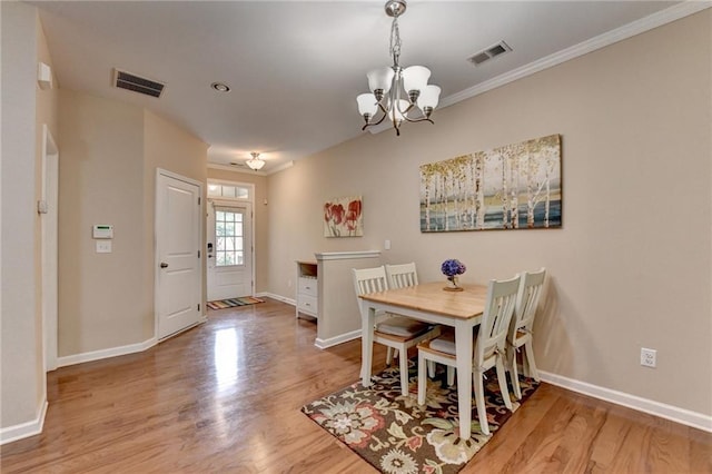 4165 Hammond Bridge Dr, Suwanee, GA 30024 - dining room with a chandelier, wood finished floors, and crown molding