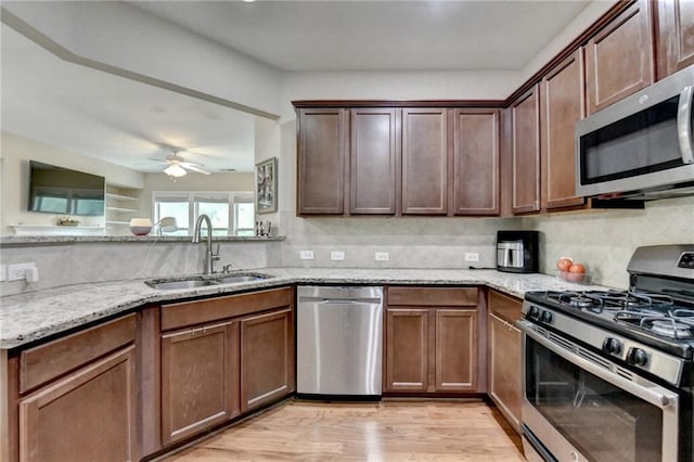 4165 Hammond Bridge Dr, Suwanee, GA 30024 - kitchen with stainless steel appliances, light stone counters, tasteful backsplash, and light wood-style floors