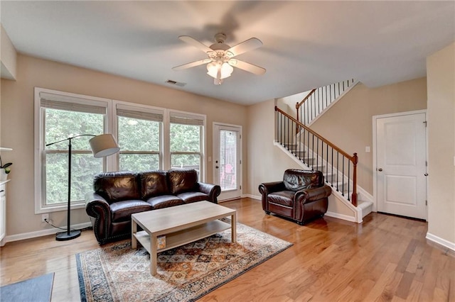 4165 Hammond Bridge Dr, Suwanee, GA 30024 - living room featuring stairway, light wood-style flooring, and ceiling fan