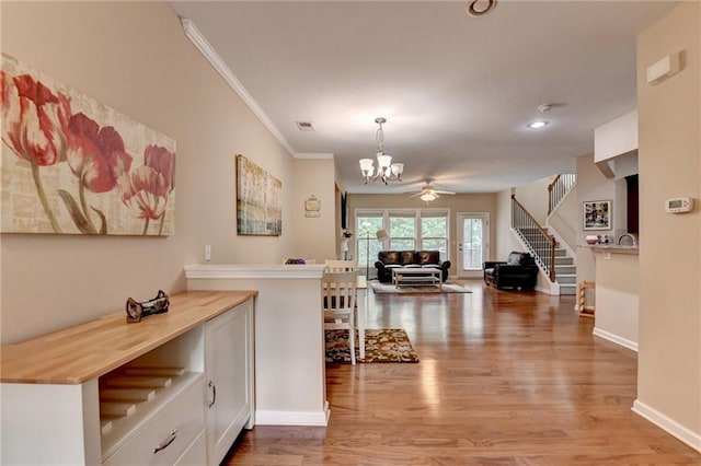 4165 Hammond Bridge Dr, Suwanee, GA 30024 - hallway featuring stairway, a chandelier, light wood finished floors, crown molding, and recessed lighting