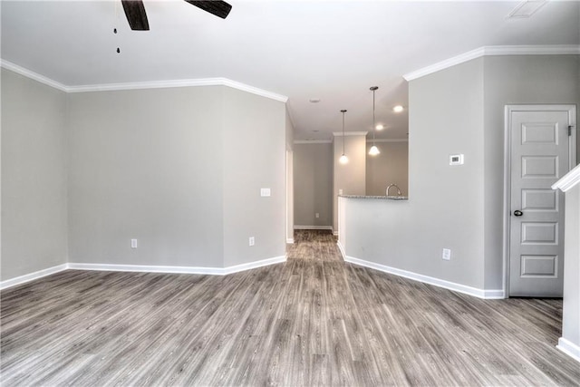 unfurnished room with ceiling fan, wood-type flooring, and ornamental molding