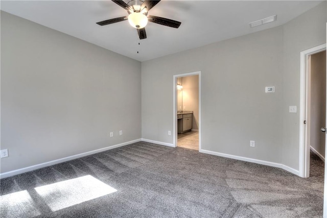 unfurnished room with ceiling fan and light carpet