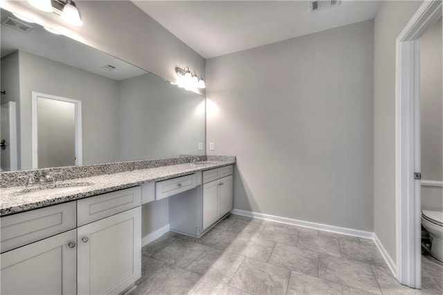 bathroom featuring vanity and toilet