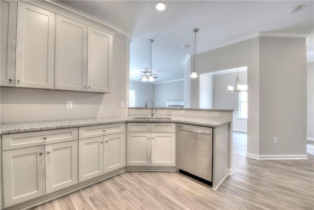 kitchen featuring dishwasher, crown molding, sink, hanging light fixtures, and kitchen peninsula