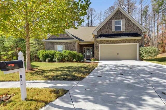 view of front of home with a front yard and a garage