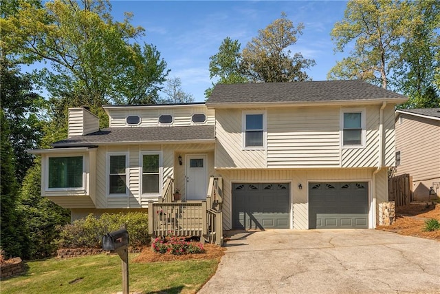 view of front of home with concrete driveway, an attached garage, a chimney, and a shingled roof